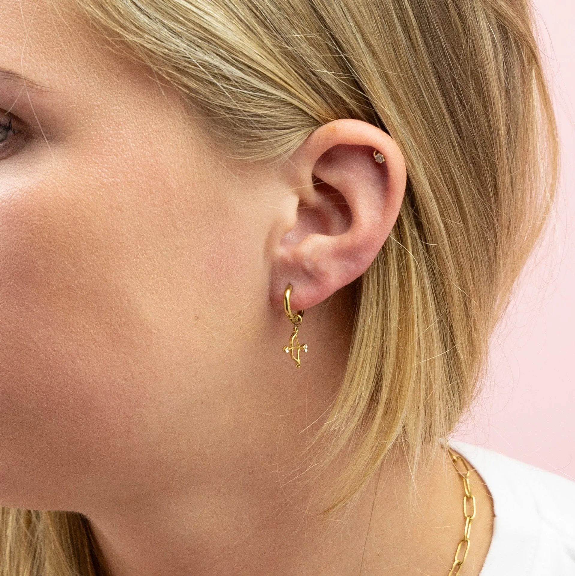 Gold coloured hoop earring with bow and arrow