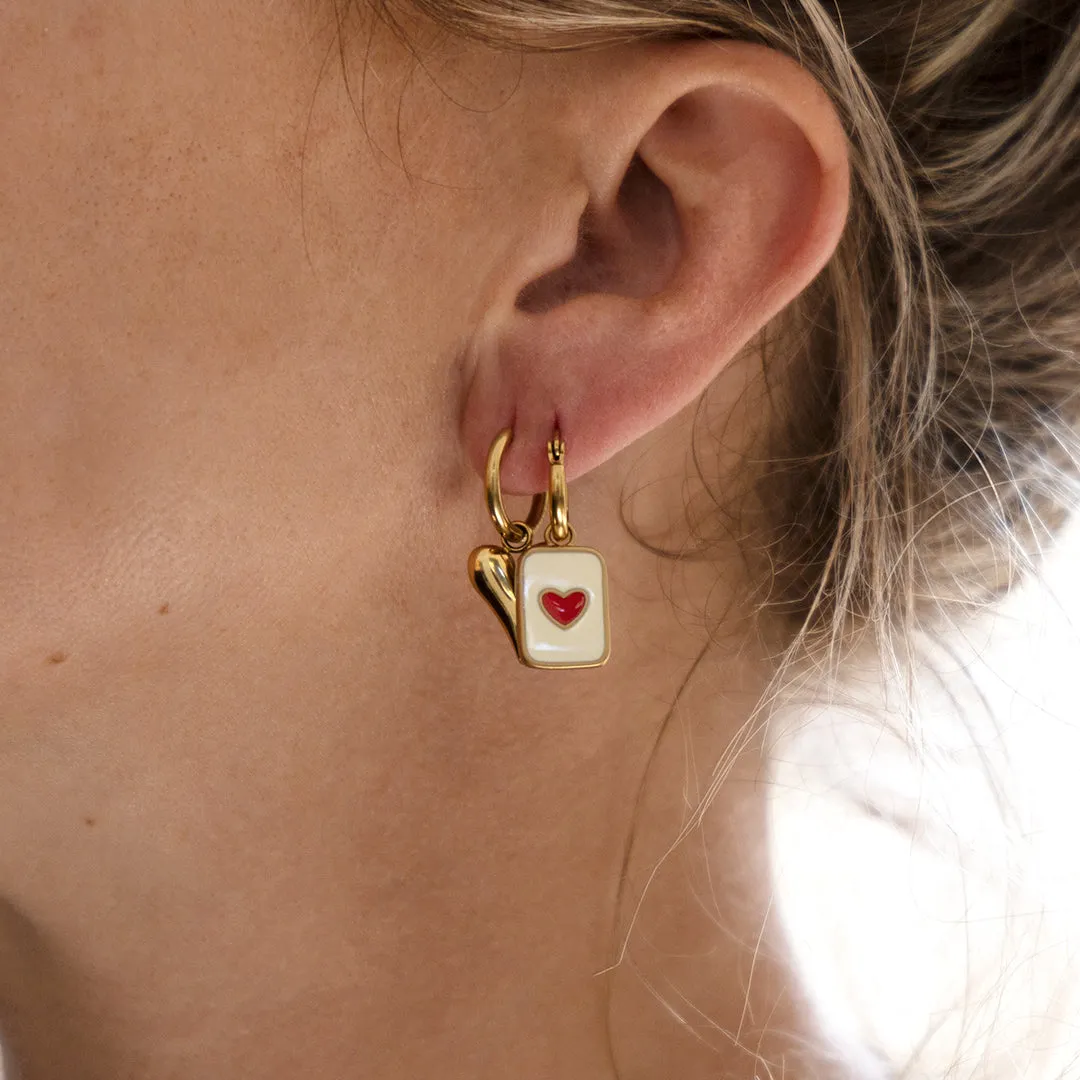 Gold coloured/red hoop earring with a heart plate